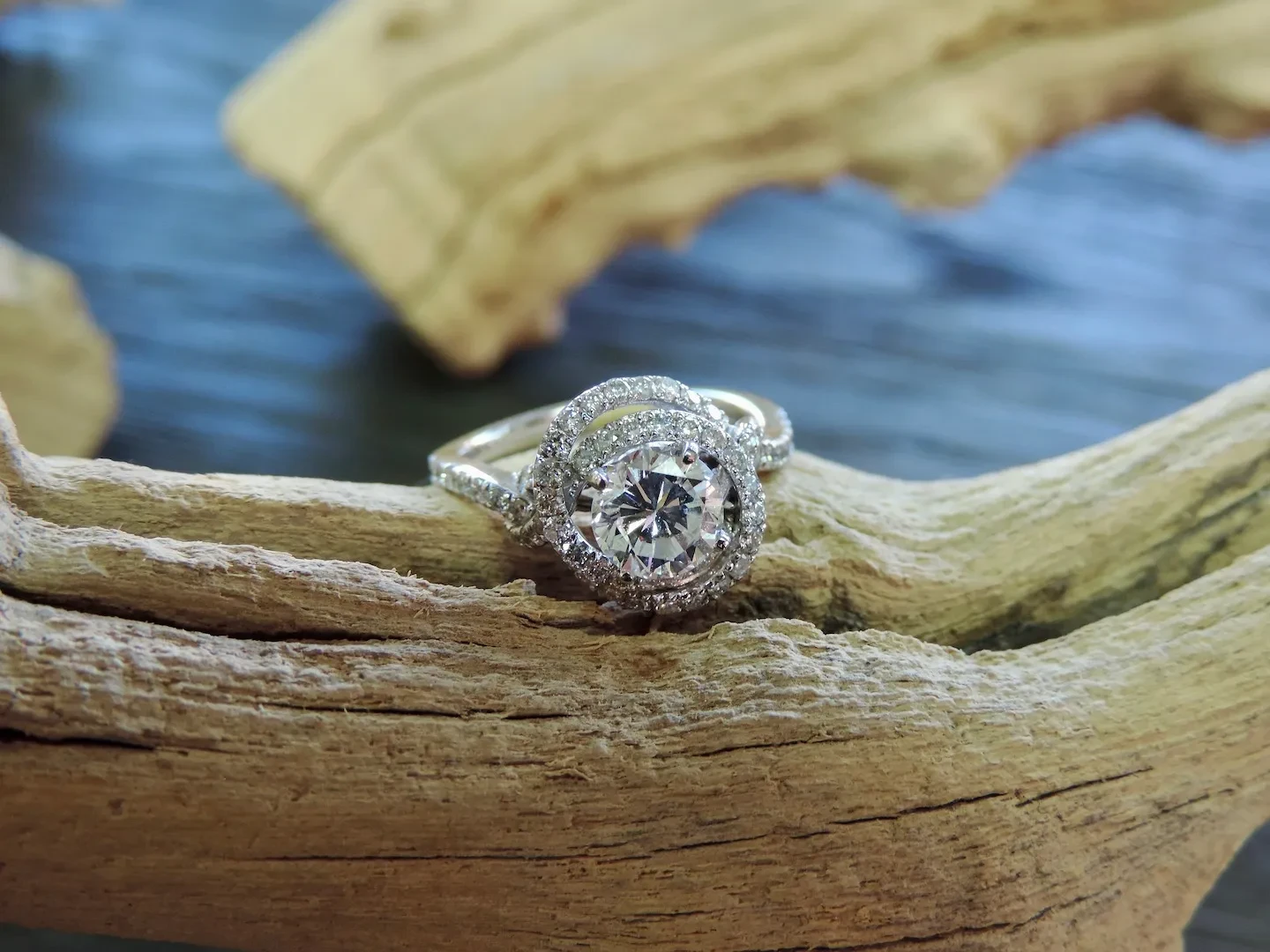 Diamond halo engagement ring on driftwood