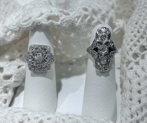 Art Deco diamond rings on white stands