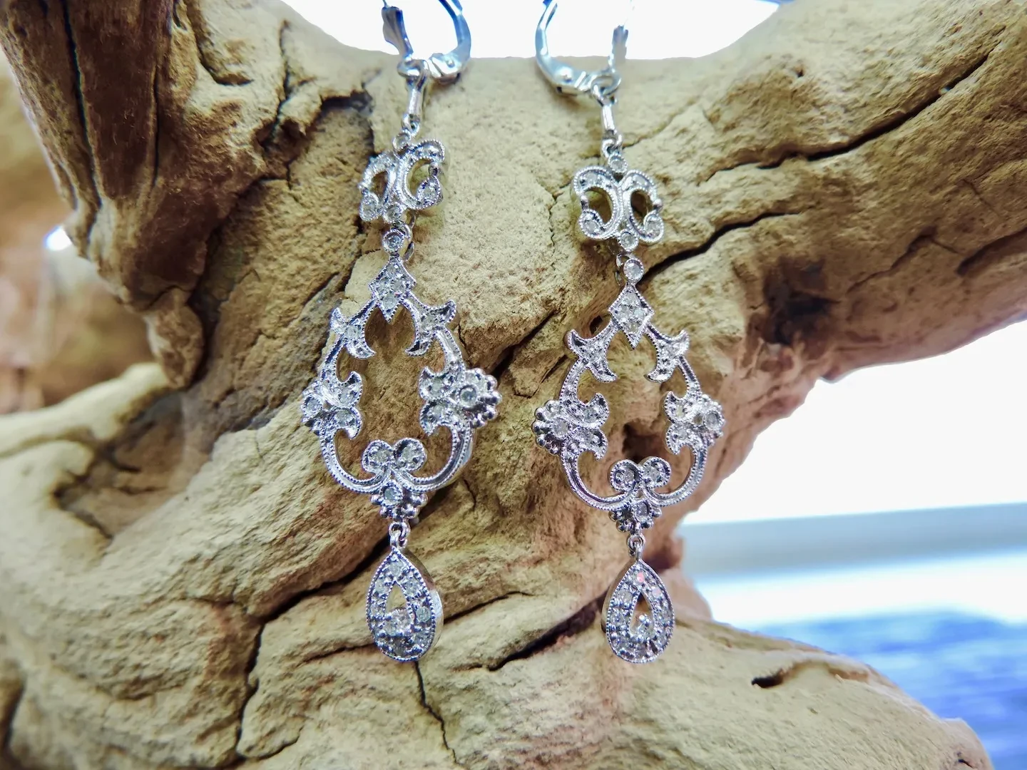 Diamond filigree chandelier earrings on driftwood