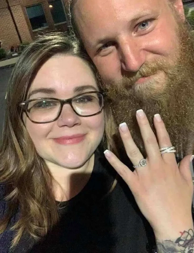 Couple showing off engagement ring together