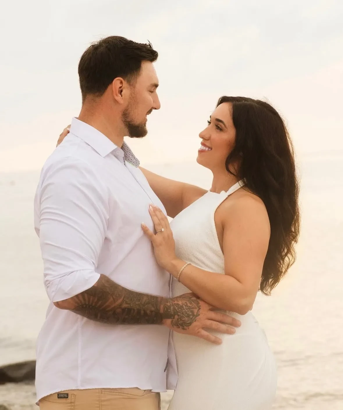 Couple embracing at sunset by the water