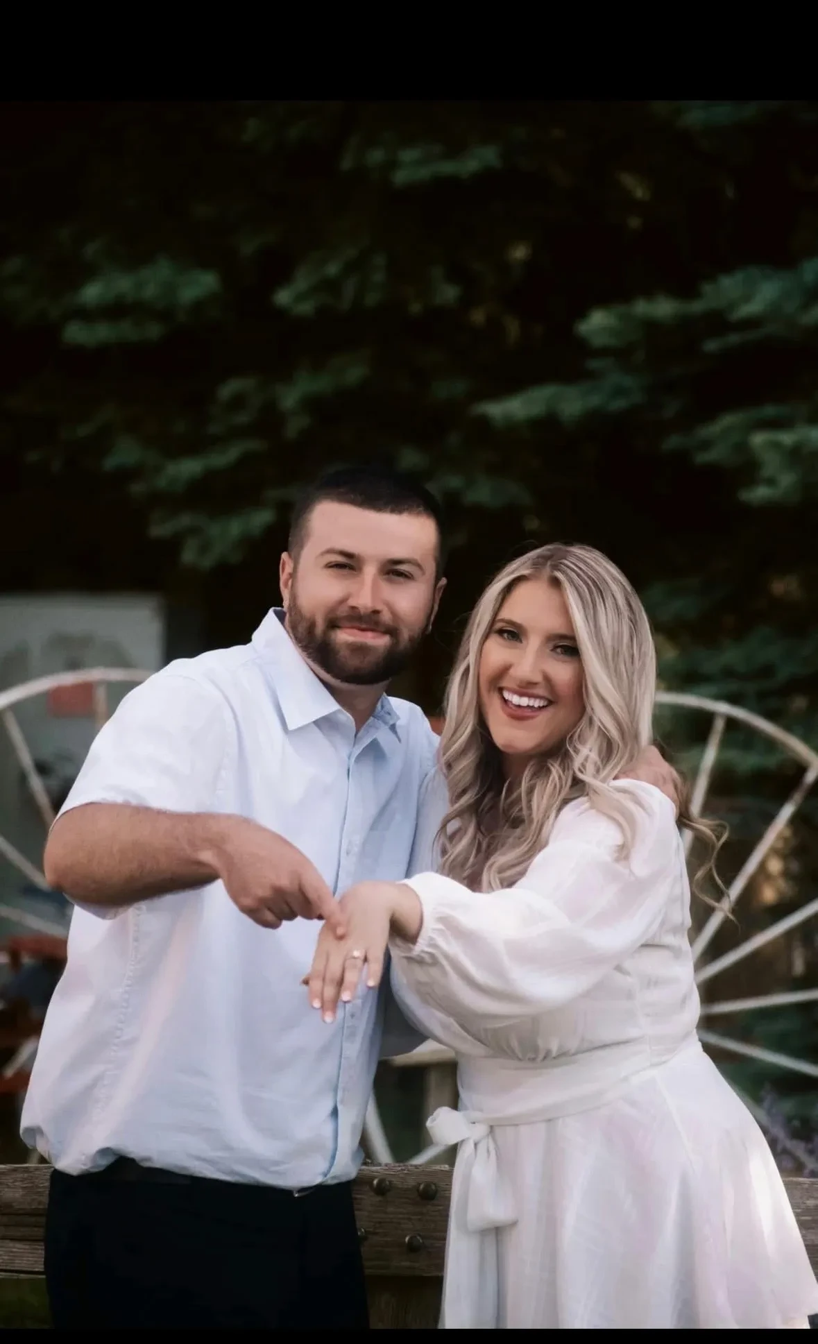 Couple showing off engagement ring