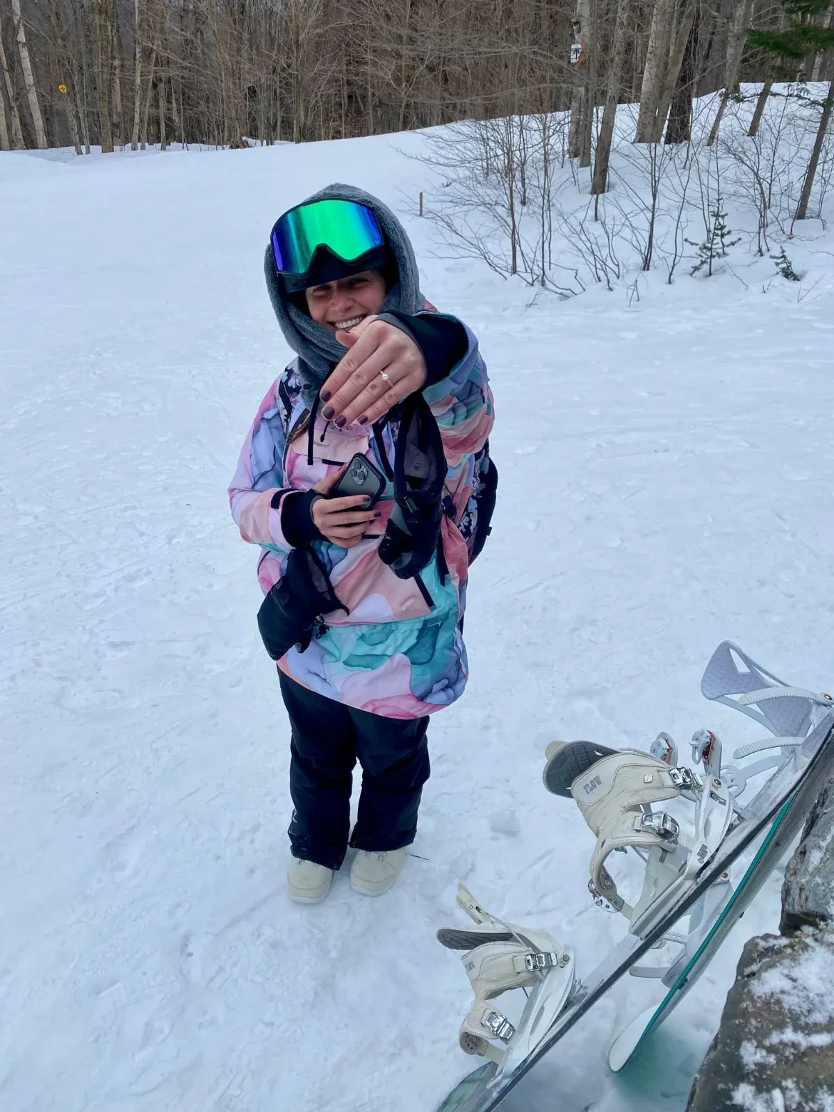 Excited bride showing her ring on the slopes